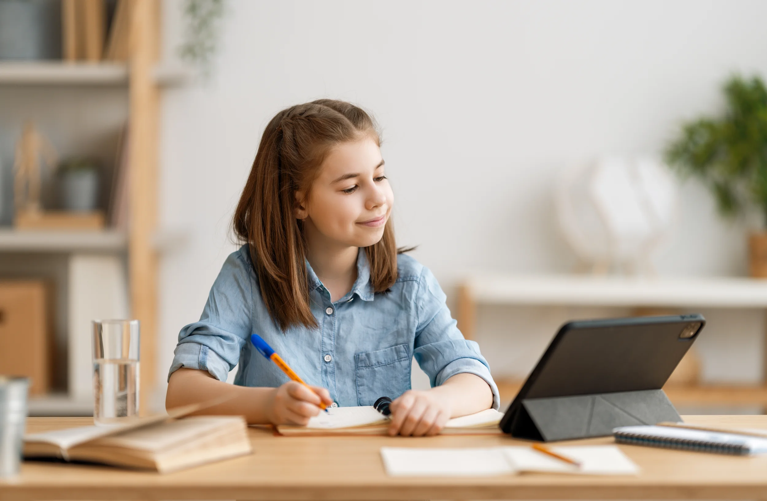 girl-studying-with-tablet-at-home-on-desk